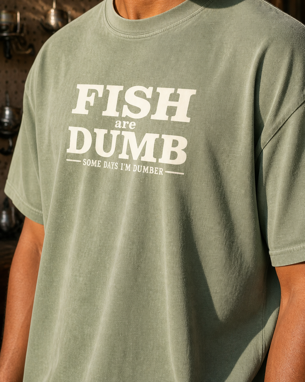 Fish Are Dumb washed tee — washed sage, worn, side
