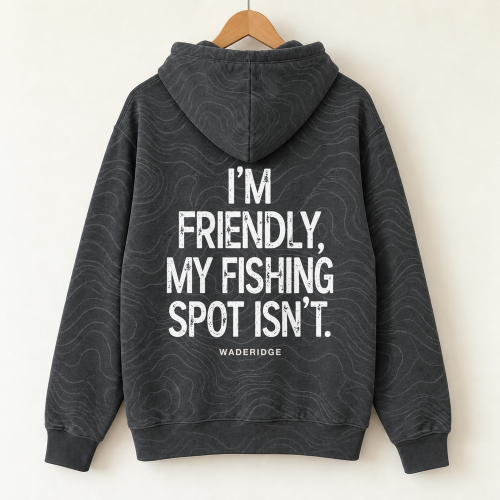 I'm Friendly My Fishing Spot Isn't All-Over Print Hoodie — on a hanger, back
