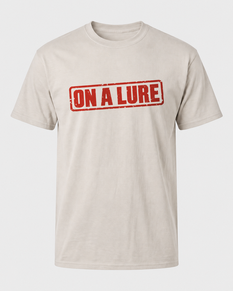 On A Lure tee — sand, front
