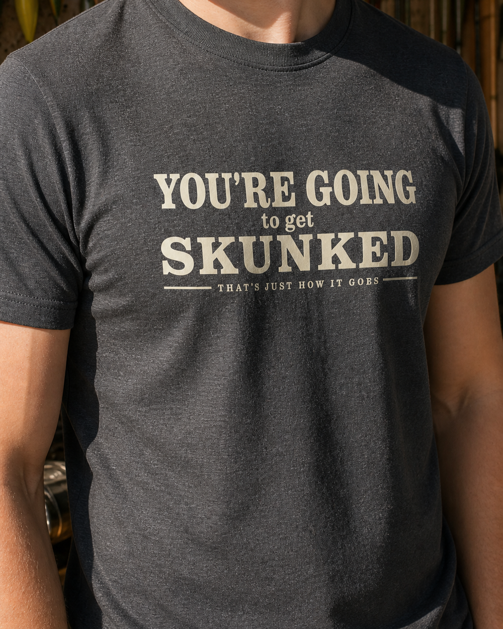 Skunked tee — dark heather, worn, side
