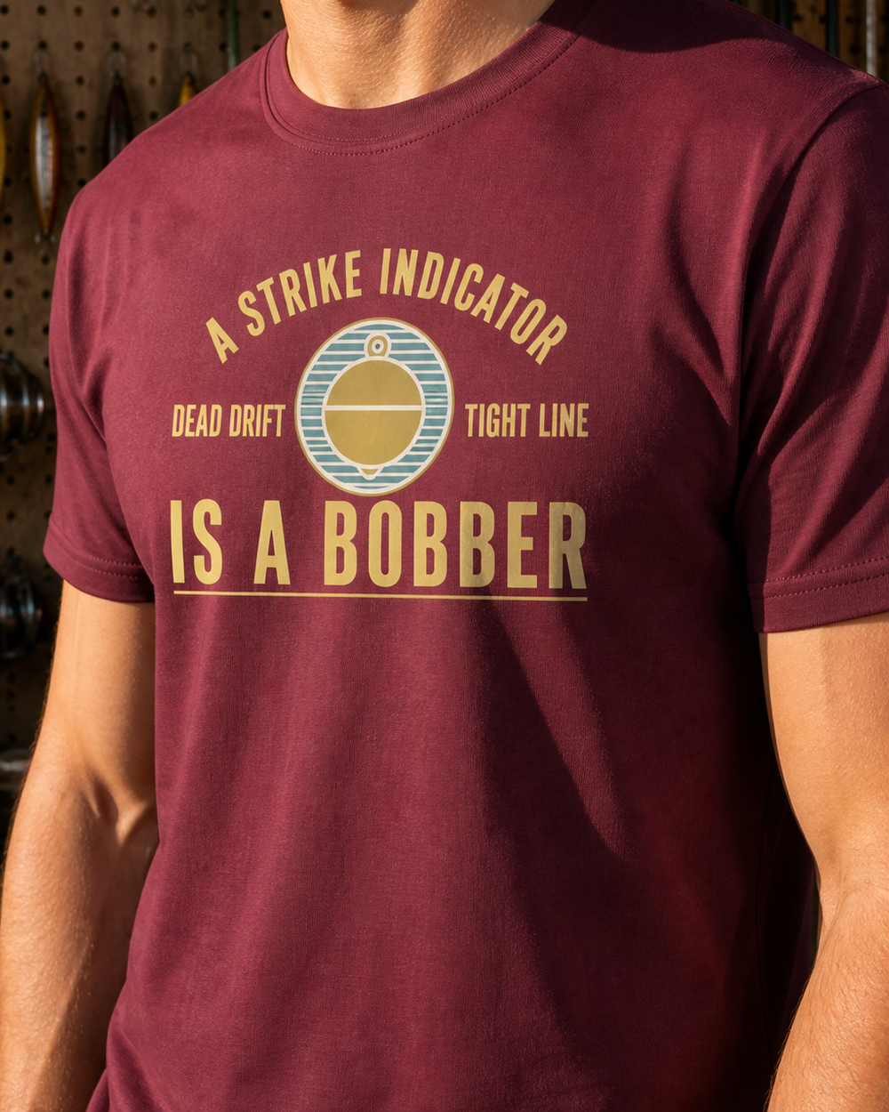 A Strike Indicator Is A Bobber tee — maroon, worn, side