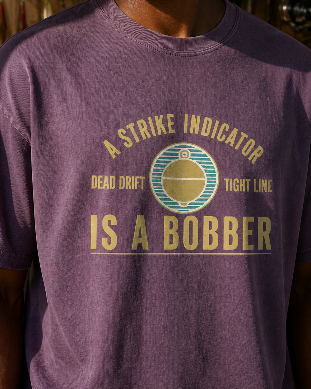 A Strike Indicator Is A Bobber washed tee — washed violet, worn, side