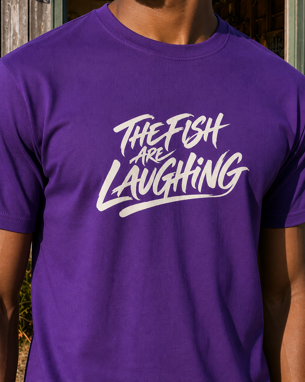The Fish Are Laughing tee — purple, worn, side