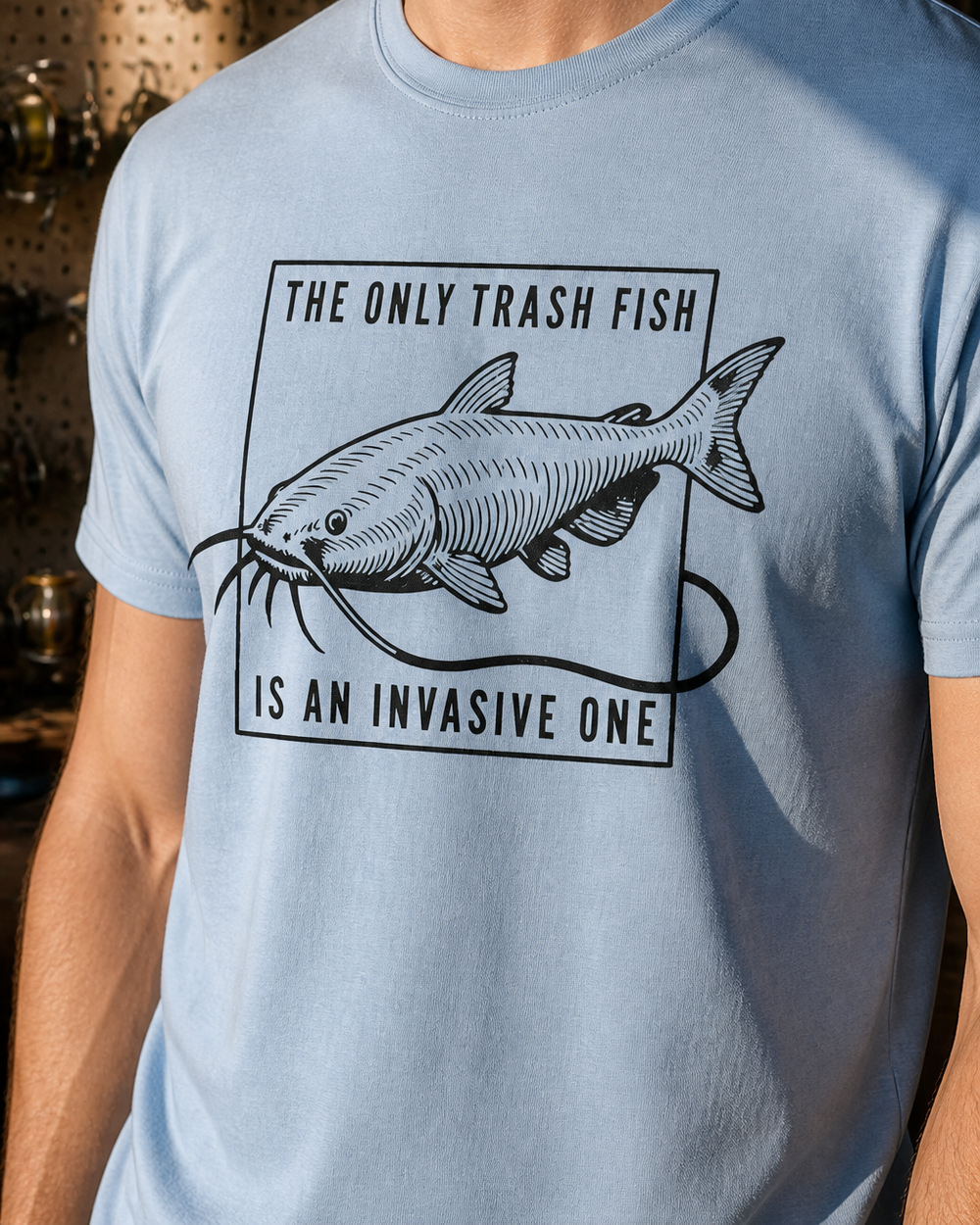The Only Trash Fish tee — light blue, worn, side