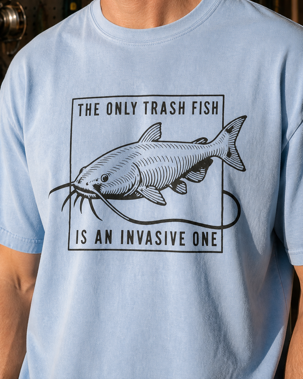 The Only Trash Fish washed tee — washed light blue, worn, side