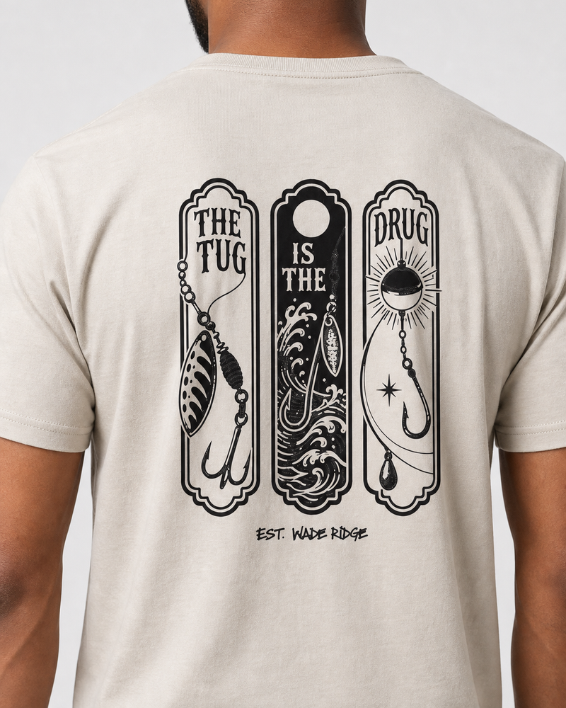 The Tug Is The Drug — Lure Panels tee — sand, worn, side