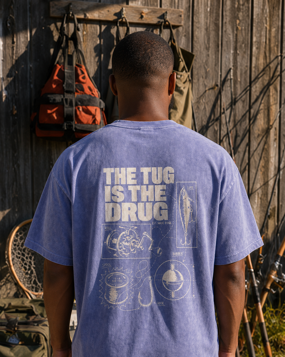The Tug Is The Drug — Tackle Notes washed tee — washed blue, worn, front